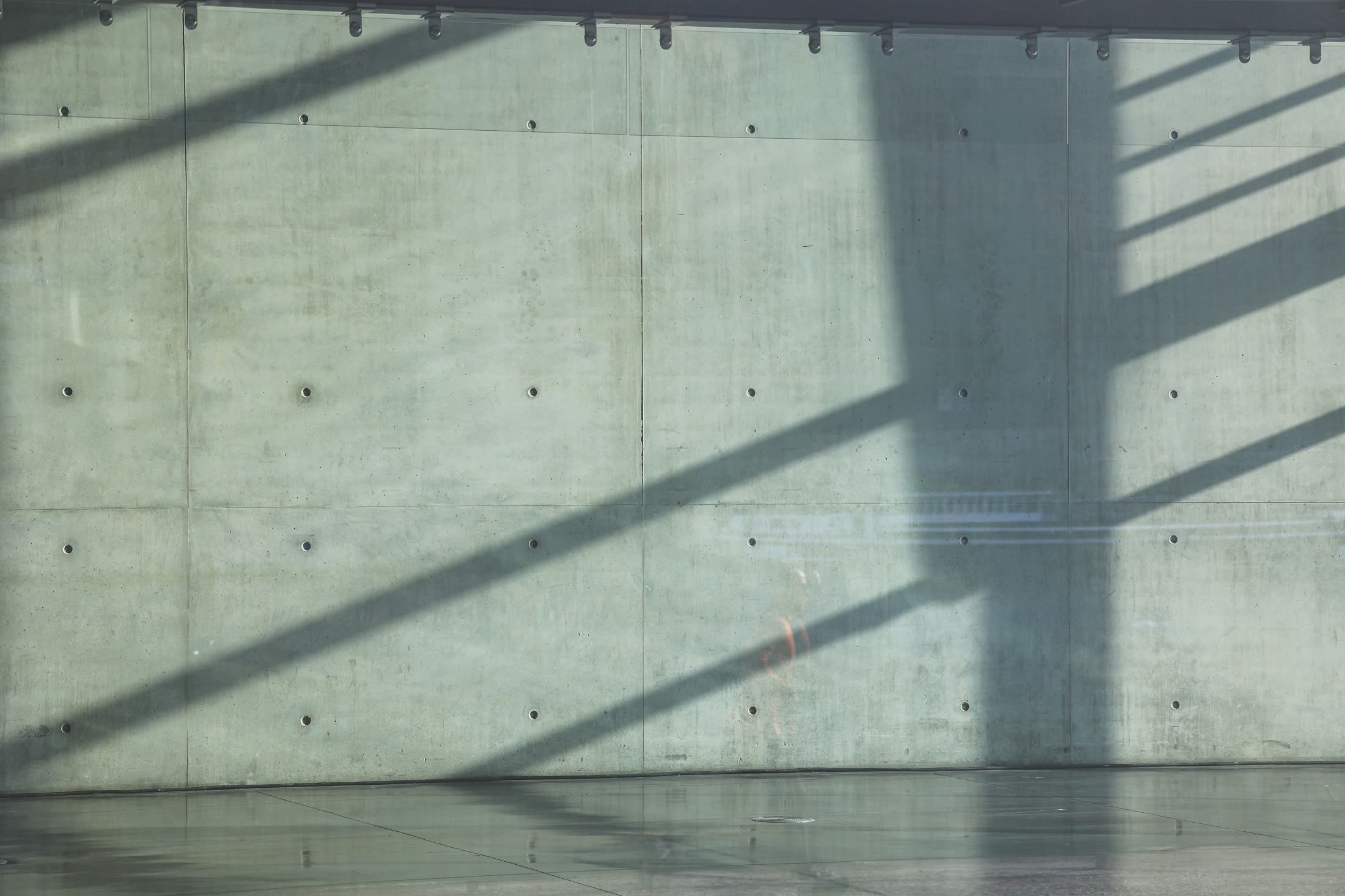Light and shadow across a concrete wall